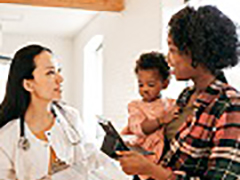 woman with child talking with doctor