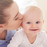 mother kissing baby