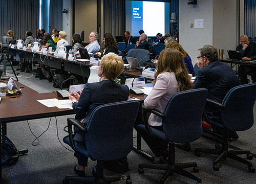 IACC members sitting around table during meeting