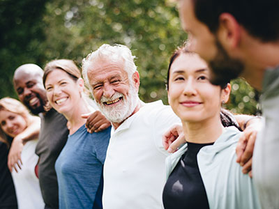 Several older adults with arms around each other