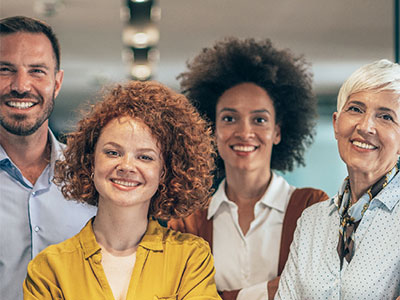 Four professional adults smiling