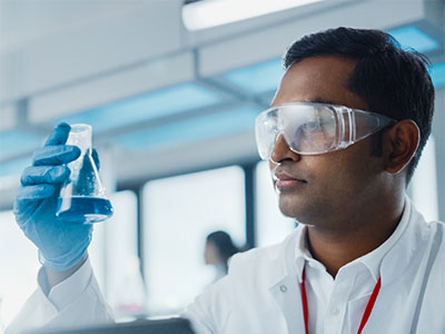 A scientist looking at a sample