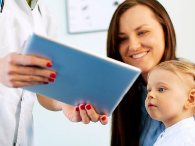 Photo of baby looking at a tablet