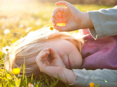 Little girl laying on grass