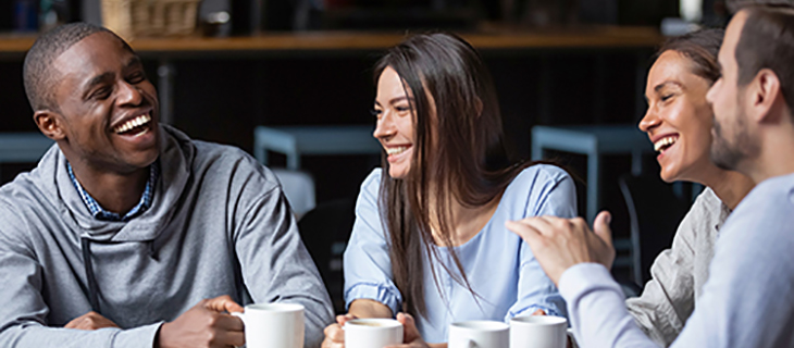 4 young adults talking while having coffee. Go to that Page