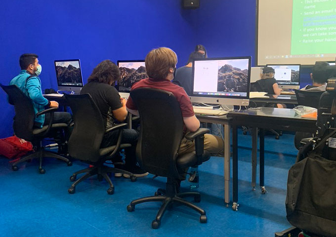 Three workers looking at their computers